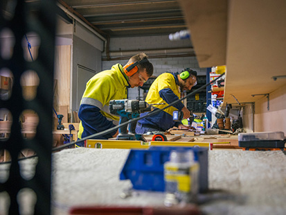 Two men working with wood.